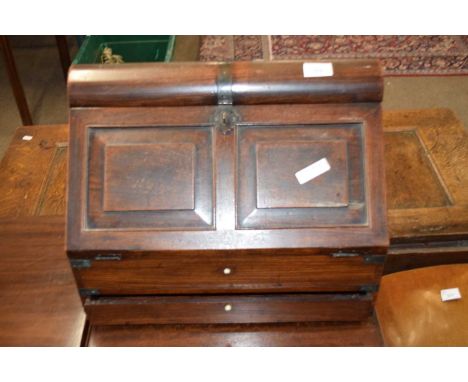 19th century colonial hardwood writing box of wedge form, the fall front opening to reveal an interior with small drawers ove
