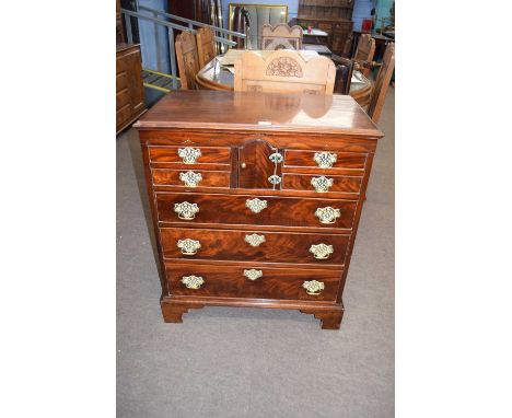 A Georgian style mahogany Norfolk chest with four small drawers, central arched door and three long drawers, raised on bracke