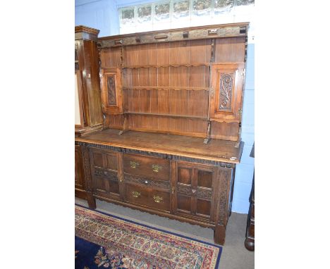 Late 19th century oak dresser, the top section with shelves and two small cupboards over a base with two doors and two drawer