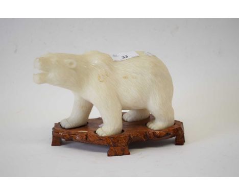 Alabaster model of a polar bear on wooden stand, 20cm long