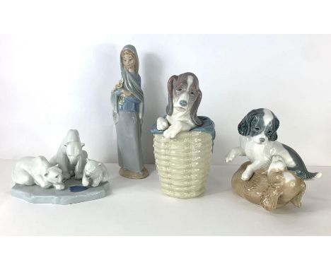 Three Lladro figures, two of puppies, one of polar bear and a Nao figure of a lady 