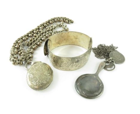 A silver hinged bangle, decorated with chased engraving throughout, 2.7cm wide; a miniature silver hand mirror; a silver chai