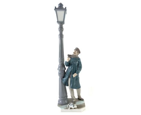 A large Lladro figure standing under a lamp post, 48cm high 