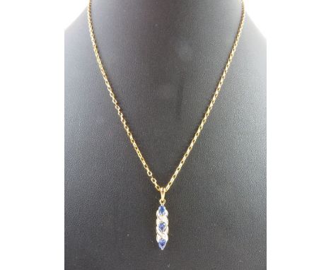 A 9ct gold tanzanite and diamond pendant, on a 9ct gold filed trace link chain, 45cm long, 3.51g gross
