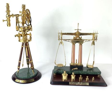 A Franklin Mint Gold Rush Miner's Transit model, along a set of Franklin Mint weighing scales