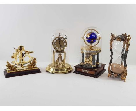 A brass model of a sextant, along with two modern domed top clocks and an elaborate model of an egg timer 