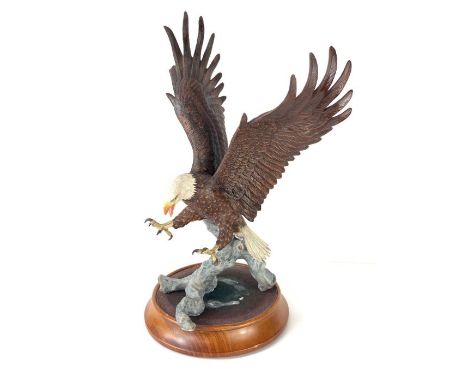 A Franklin Mint ceramic figure 'American Majesty' by Ronald Van Ruyckevelt, on wooden base, 36.5cm high