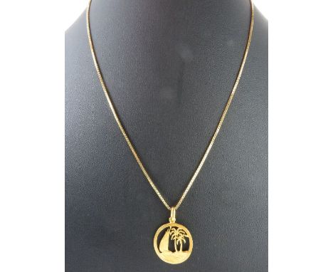A round pendant with cut out design of a sailing boat on the seas, unmarked, tests as 18-22ct gold, 2.37g gross; and a fine b
