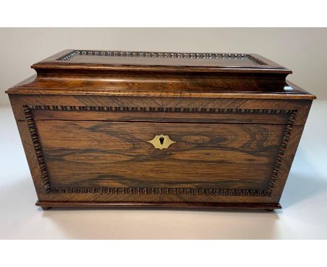 A 19th century rosewood sarcophagus tea caddy, with removable sections and glass caddy 