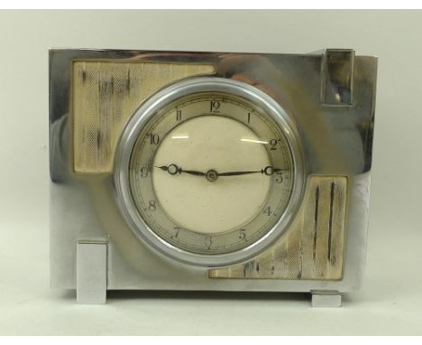 A 1930's Art Deco Chrome clock with enamel, face, silvered dial and Arabic numerals, with ABEC stamped within a stylised cloc