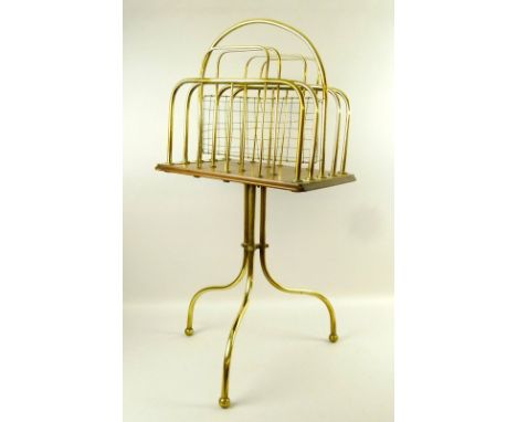 A Victorian brass book rack, the oak top raised on a brass tripod base, 36 by 45 by 76cm high.