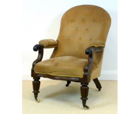 A Regency mahogany library chair, with carved open arms and padded rests, upholstered in green gold velour with a button back