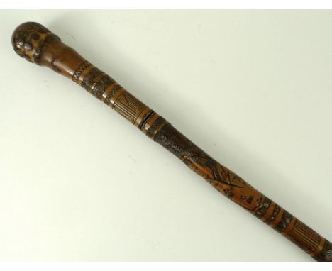 A Japanese bamboo sword stick carved all over with figures and birds, 89cm long. 