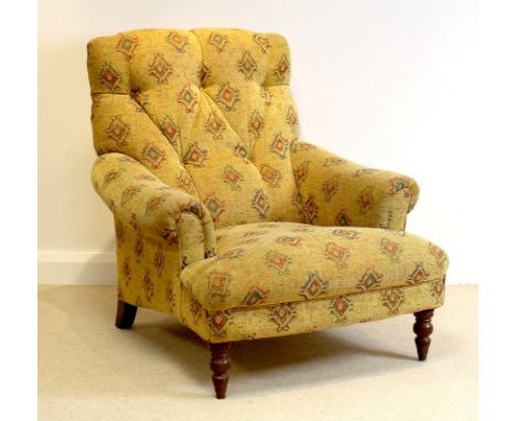 A Victorian style, button back low armchair, upholstered in yellow diamond patterned fabric, raised on turned front supports,