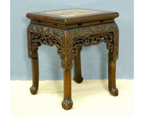 A Chinese 19th century hardwood urn stand, with carved lion's paw feet, lattice and scroll work below the rim, the top inset 