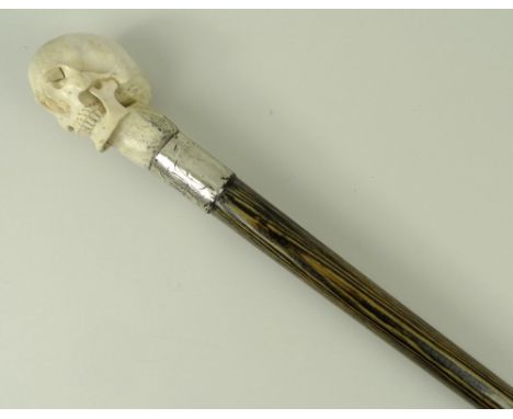 A Victorian palm wood walking stick with an antler knop carved as a Momento Mori skull, silver ferrule monogram engraved, hal