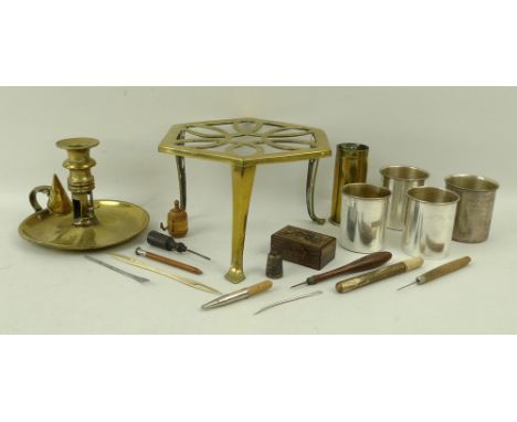 A group of collectables, comprising a brass trivet, shell casing, chamber stick with snuffer, a set of four silver plated gra