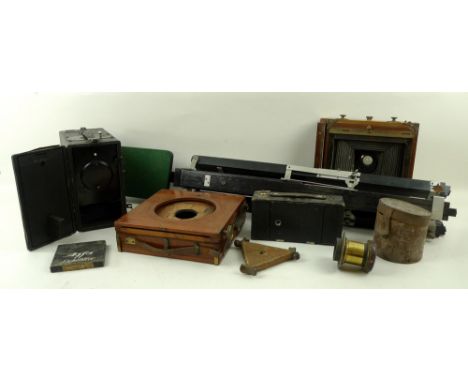A collection of camera equipment including a bellows camera, complete with early roller shutter, a further bellows camera, a 