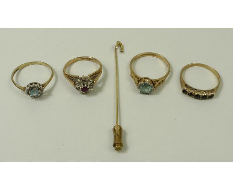 A collection of 9ct gold rings comprising two set with aquamarines, one a ruby and diamond ring, and a five stone sapphire ri