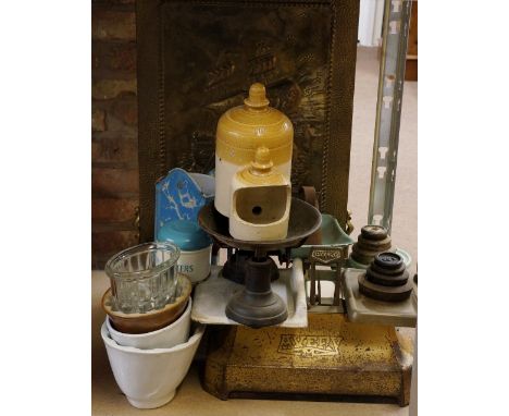 A brass fire guard, three sets of kitchen scales, salt glazed and other jelly moulds, coffee grinder, pastry cutter tin etc. 