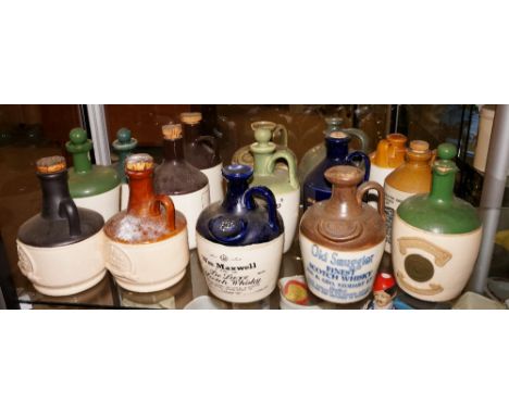 A quantity of advertising pottery decanters including: Old Smuggler Finest Scotch Whisky, other whisky's, ciders, etc. (15)