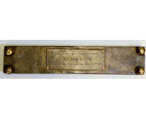 A cribbage board made from wood taken from HMS King Alfred after being torpedoed on April 15th, 1918, brass feet, the base wi