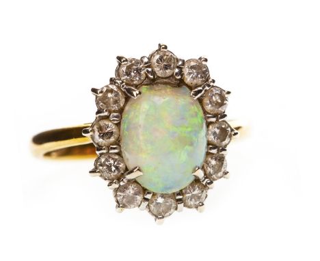 OPAL AND DIAMOND RING, the oval opal 8.7mm long and surrounded by round brilliant cut diamonds, marked 750, size K, 3g