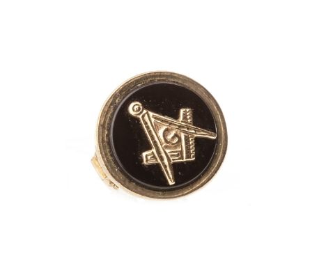 NINE CARAT GOLD MASONIC FOB, formed by a compass with overlaid trowel, gavel and keystone motifs, 33mm high, the black hardst