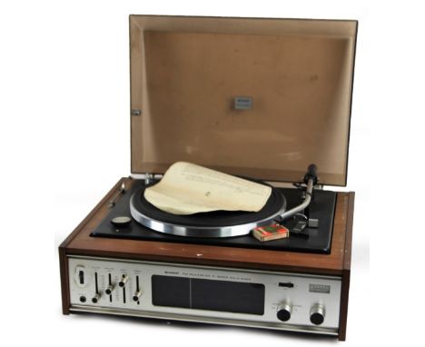 A vintage Sharp Solid State turntable, with three band multiplex radio, in a teak cabinet with plastic casing, 28cm H, 50cm W