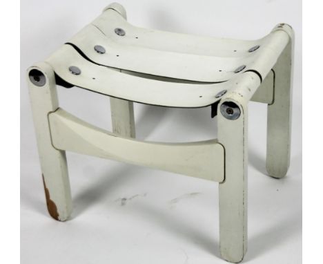 A vintage 1970's stool, with strap work top, on rounded stiles with metal studding, 50cm H, 60cm W, 49cm D.