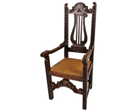 An early 20thC carved oak carver chair, with shaped top, lyre splat, flowerhead surround and acanthus capped and flowerhead a
