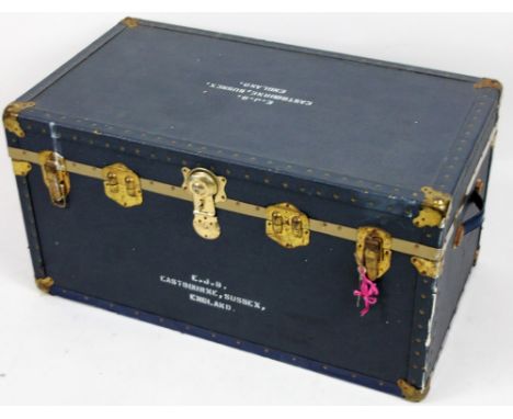 A 20thC steamer trunk, in blue pressed leather, of rectangular form, partially studded with side handles and heavy metal lock