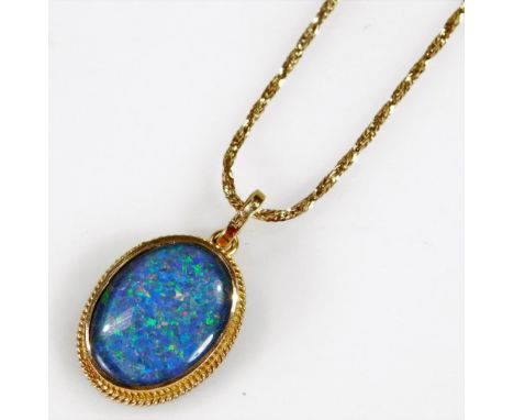 An imitation opal pendant, set with black back imitation opal, in gold plated frame, on a twist design chain, marked 585 1/20