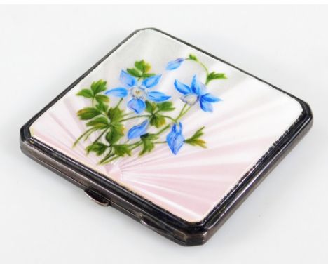 A mid 20thC silver and enamel powder compact, decorated with flowers with a sunburst backing in pink and blue, with canted co