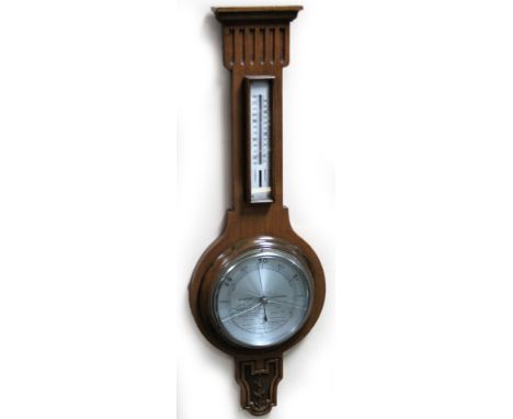 A 20thC oak two dial banjo barometer, and thermometer, in a carved case with 16cm Dia. dial, 72cm H.