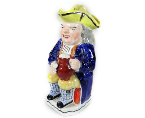 A Victorian Staffordshire pottery Toby jug and cover, the seated figure in blue waistcoat, yellow, blue and black breeches, h