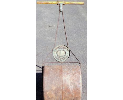 An early 20thC Griffin Ironmonger garden roller, with wooden handle and metal frame, 104cm H.