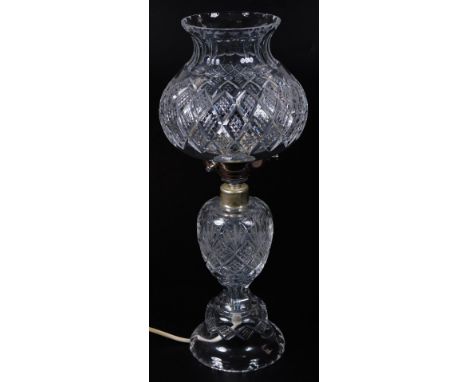 A 20thC crystal lamp, with bulbous shade, set with a repeat hobnail cut diamond pattern, on shaped stem and base, Waterford s