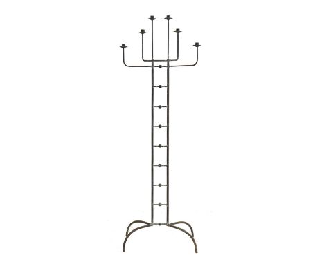 An Art Deco wrought iron candelabra, c.1920, on a splayed foot, for six candles, the central structure with ornamental sphere