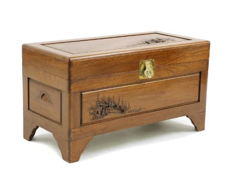 A camphorwood chest, with carved decoration to the front and top, the sides with carved, recessed handles, 93cm long x 53cm h