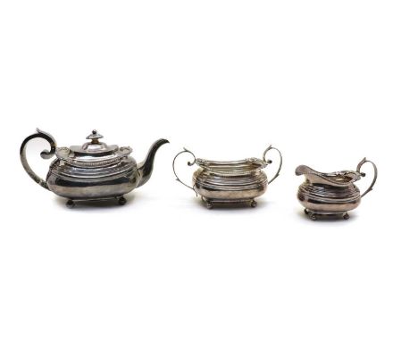 A George III silver three piece teaset, John Webb, Exeter 1817, of bombe form with a cast rim of toothed form with shells and