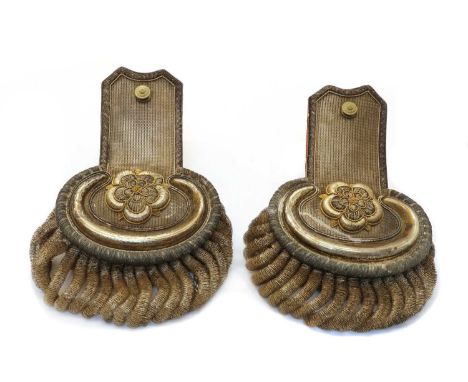 A pair of 19th Century epaulettes, with floral designs in white and gilt metal, marked to the underside 'J.B. &amp; F. Wells,