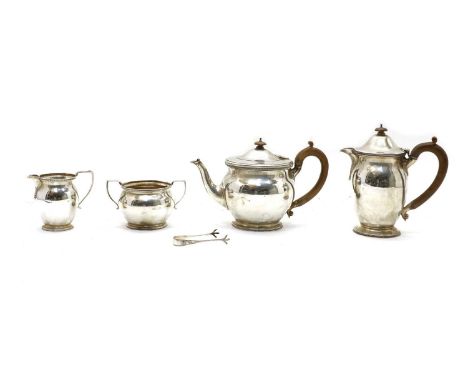 A silver four piece tea service, by S &amp; Co., London 1926, of circular shape with heraldic engraving: 'En Avant'. Base ins