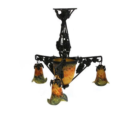 An Art Deco-style wrought iron three-branch electrolier, with grapevine details, the modern mottled glass shades etched, 'Ver