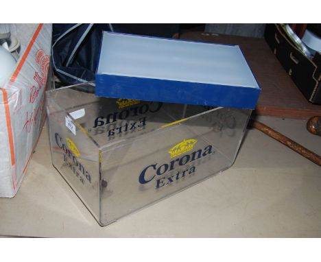 A clear Perspex Corone Extra crate and a diffused wall light.