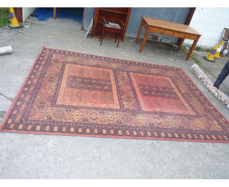 A large maroon and black ground carpet, 131" x 94".
