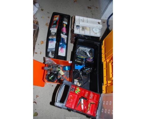 Three boxes of fishing tackle to include: reels (one being a "Penn" reel), flies, floats, etc.