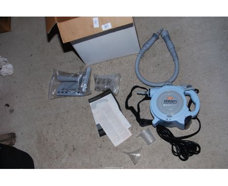 A "Vax" compact steam cleaner with attachments.