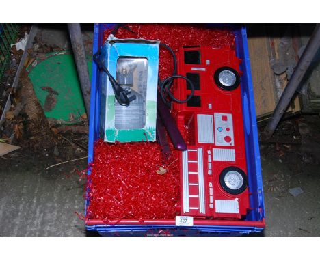 A crate of miscellaneous to include: hair straighteners, camping gas stove and a toy fire engine.