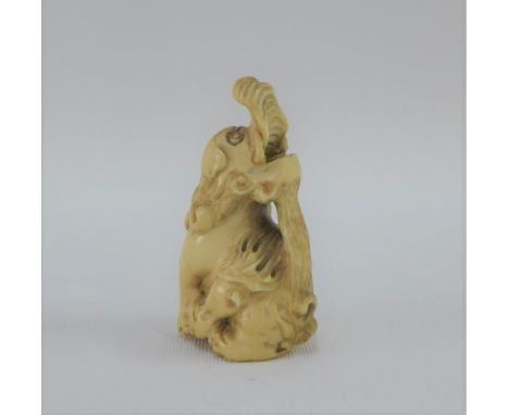 Ivory Netsuke in the form of a Temple Dog, signed, 5.5cm high 